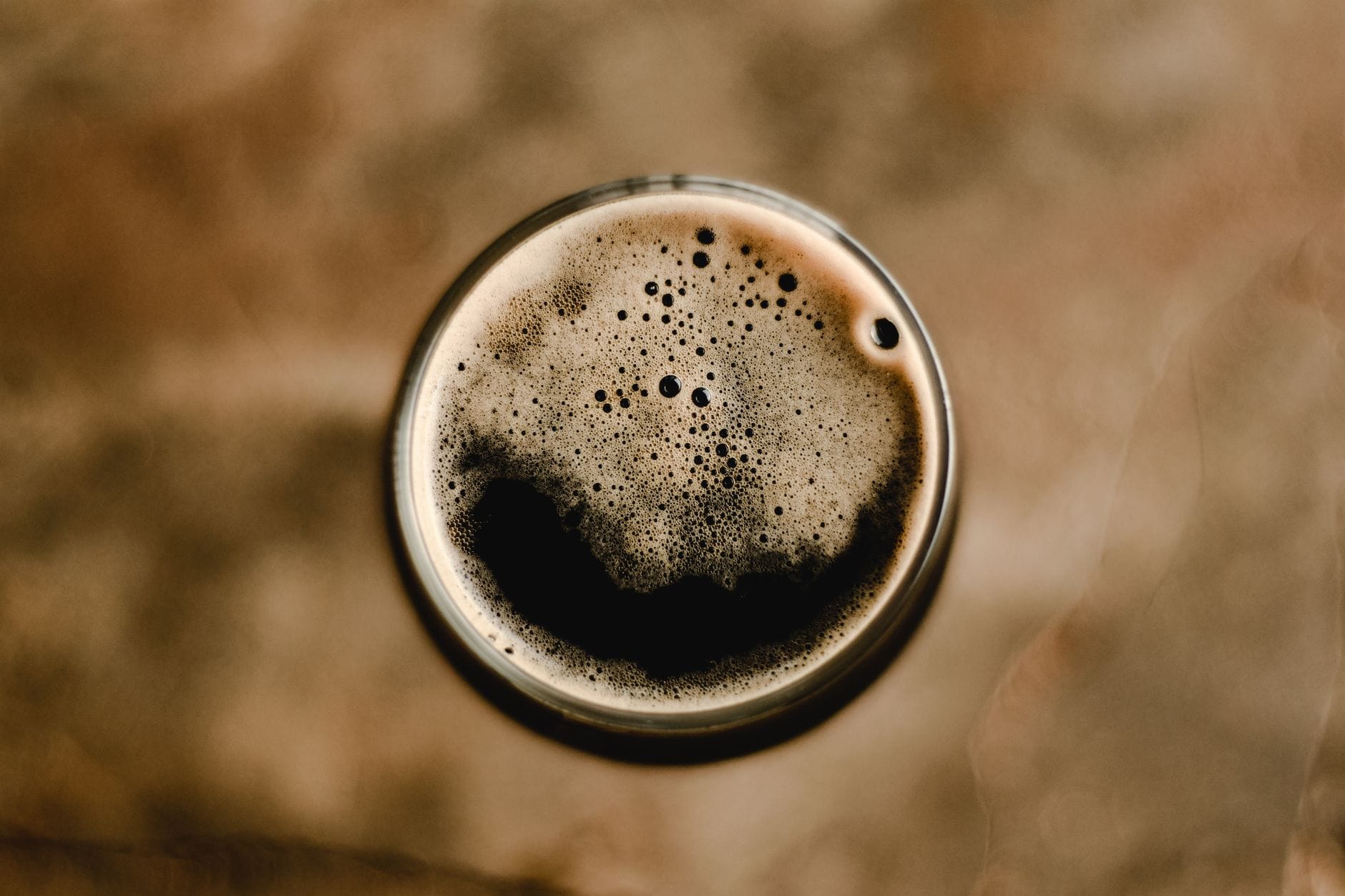 Domowa receptura na piwo owsiane stout kremowe i aksamitne w odbiorze Piwo owsiane stout z pianką widziane z góry w szklance